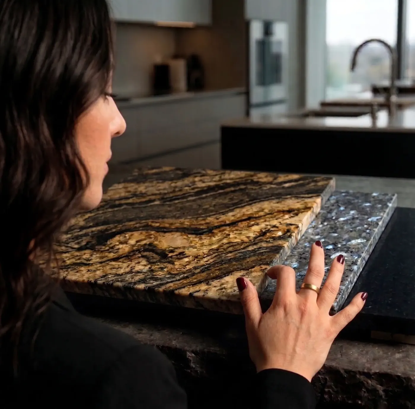 Comparing two granite sample slabs on a worktop